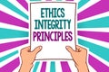 Word writing text Ethics Integrity Principles. Business concept for quality of being honest and having strong moral Man holding pa