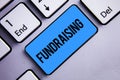 Word writing text Fundraising. Business concept for Seeking of financial support for charity cause or enterprise Keyboard blue key Royalty Free Stock Photo