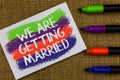 Word writing text We Are Getting Married. Business concept for Engagement Wedding preparation Loving couple Colorful waves with wh