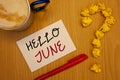 Word writing text Hello June. Business concept for Starting a new month message May is over Summer startingIdeas on paper red pen