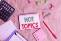 Word writing text Hot Topics. Business concept for subject that a lot of showing are arguing and discussing Papercraft Royalty Free Stock Photo