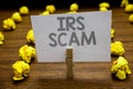 Word writing text Irs Scam. Business concept for targeted taxpayers by pretending to be Internal Revenue Service Clothespin hold h