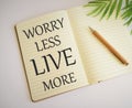 Word writing text Live More Worry Less in Notebook. Business concept for Have a good attitude motivation be careless enjoy life Royalty Free Stock Photo