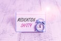 Word writing text Medication Safety. Business concept for freedom from preventable harm with medication use Mini blue alarm clock