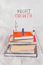 Word writing text Profit Growth. Business concept for Objectives Interrelation of Overall Sales Market Shares pile stacked books