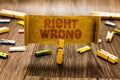 Word writing text Right Wrong. Business concept for choose between two decisions correct and bad one to make Clothespin holding ol Royalty Free Stock Photo