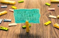 Word writing text Slow Down Relax Destress. Business concept for calming bring happiness and put you in good mood Clothespin holdi