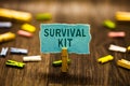 Word writing text Survival Kit. Business concept for Emergency Equipment Collection of items to help someone Clothespin holding bl