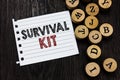 Word writing text Survival Kit. Business concept for Emergency Equipment Collection of items to help someone Piece notebook paper