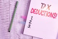 Word writing text Tax Deductions. Business concept for reduction income that is able to be taxed of expenses Thick pages