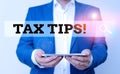 Word writing text Tax Tips. Business concept for compulsory contribution to state revenue levied by government Man in