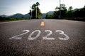 The word 2023 is written on an empty road.
