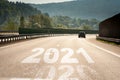 The word 2021 written on highway asphalt road. Concept for new year 2021 or planning and challenge or career path. Future journey Royalty Free Stock Photo