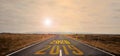 The word 2020 written on highway road in the middle of empty asphalt road at golden sunset and beautiful blue sky. Royalty Free Stock Photo