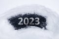 The word - 2023 is written on the ice cleared of snow. cold 2023