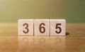 365 word written on wooden blocks on wooden table. New Days 365 New Chances Royalty Free Stock Photo