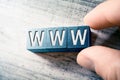 The Word WWW On Wooden Blocks And Arranged By Male Fingers On A Table Royalty Free Stock Photo