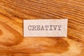 The word "creativy" typed. The inscription on a gray sheet of pappier