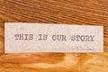 The word "this is our story" typed. The inscription on a gray sheet of pappier Royalty Free Stock Photo