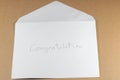 Wording Congratulation of white envelope on brown background Royalty Free Stock Photo