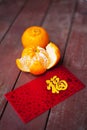 Wording of happiness on the red packet with tangerines.