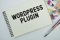 Wordpress Plugin text message written on notepad with stationery flat lay on white background Royalty Free Stock Photo
