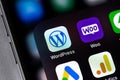 WordPress, WooCommerce mobile icon apps on a screen smartphone iPhone closeup. WordPress - open source site content management