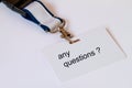 The words any question on a white name tag on a tape Royalty Free Stock Photo