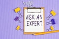 The words ask an expert written on a white notebook Royalty Free Stock Photo