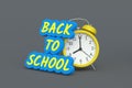 Words back to school near alarm clock. Concept of education