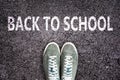 Words Back to school written on asphalt road with sneakers shoes, high school and college concept