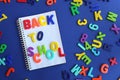 The words back to school are written on a blue background Royalty Free Stock Photo