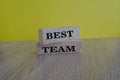 Words \'Best team\' symbol on brick blocks on a wooden table