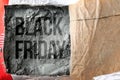 The words Black Friday on the background of dry cement in torn packaging. Annual sale of goods in the hardware store