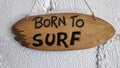 The words `Born to Surf` on the wooden boards
