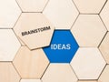 Words brainstorm and ideas on wooden hexagon. Business innovation concept.