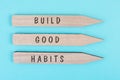 The words build good habits are standing on arrows, change lifestyle, healthy and positive attidude, motivation concept Royalty Free Stock Photo