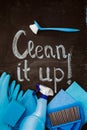 The words `clean it up!`on the chalkboard above the blue spring cleaning kit.