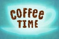 The words coffee time made from coffee beans on a blue abstract background Royalty Free Stock Photo