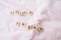 The words color trend is written in cubic letters on a pink color textile background, selective focus Royalty Free Stock Photo
