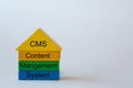 The words: Content, Management System are written on colorful blocks. The abbreviation CMS stands as the building block roof Royalty Free Stock Photo