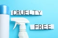 Words Cruelty Free and detergents not tested on animals against light blue background, flat lay