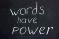 Words on a dark board with white chalk: `words have power