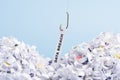 Words Data breach hooked on fishing hook pulled from pile of shredded documents