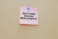 Words of Don't Make Excuses Make Progress on sticky color papers stick on brown cardboard Royalty Free Stock Photo