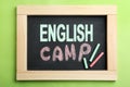 Words ENGLISH CAMP on small blackboard and colorful chalk