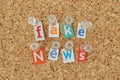 Words Fake News written with cut out magazine letters on bulletin board Royalty Free Stock Photo