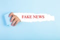 Words Fake News written under torn paper Royalty Free Stock Photo