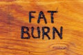 The words fat burn handritten on wooden surface with woodburner Royalty Free Stock Photo