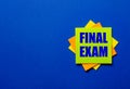 The words FINAL EXAM is written on bright stickers on a blue background Royalty Free Stock Photo